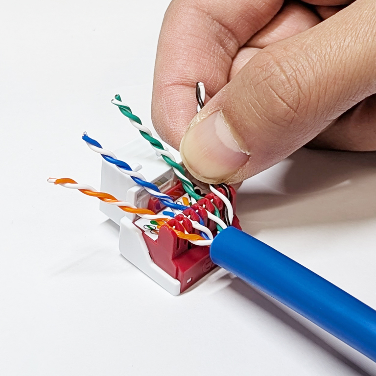 CAT6A keystone jack showing inline IDC pair-to-pair wire termination